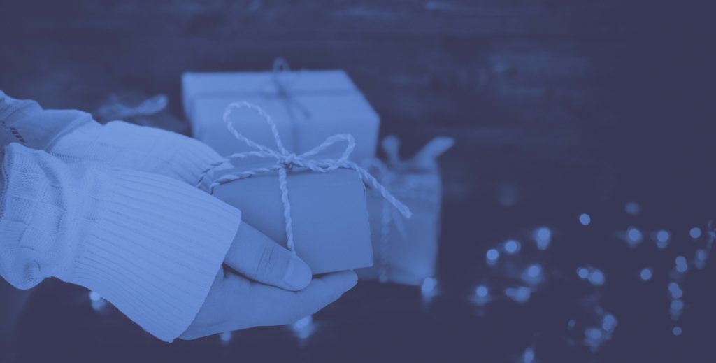 Holiday shopper holding gift in hands