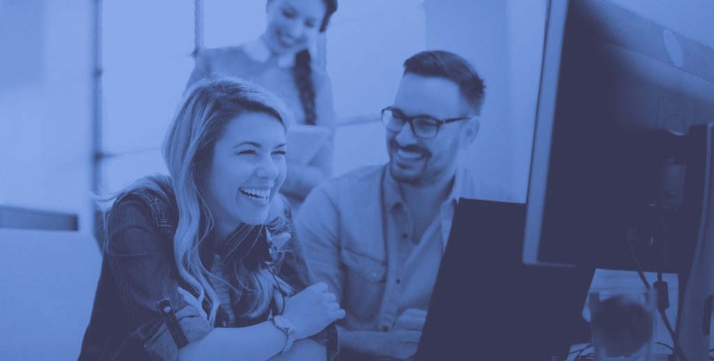 Man and woman laughing in office