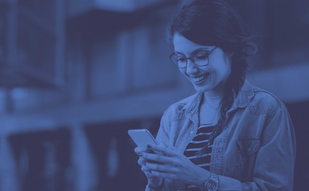 Girl smiling at phone
