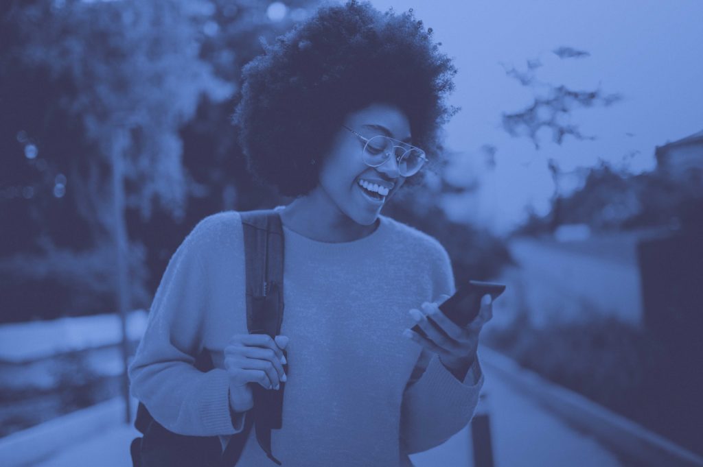 girl on phone walking outside