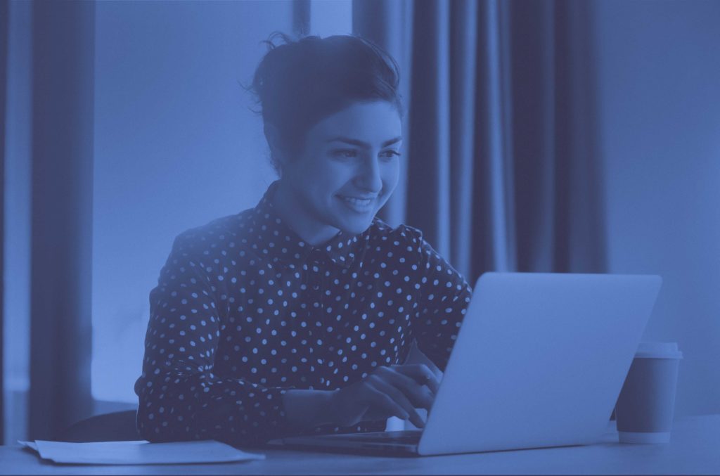 Woman smiling on laptop
