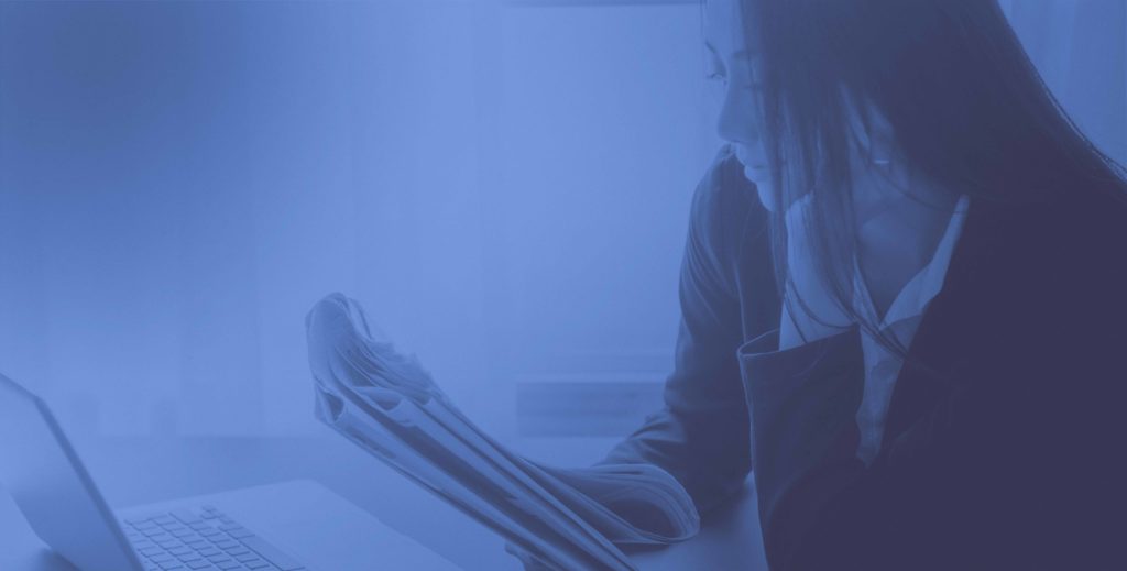 girl reading newspaper