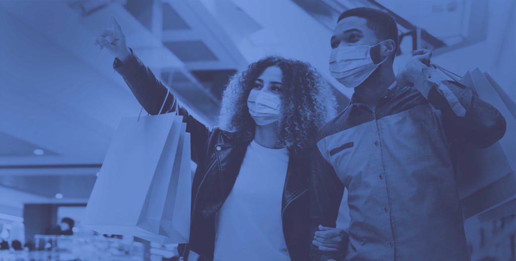 two people with shopping bags and masks on